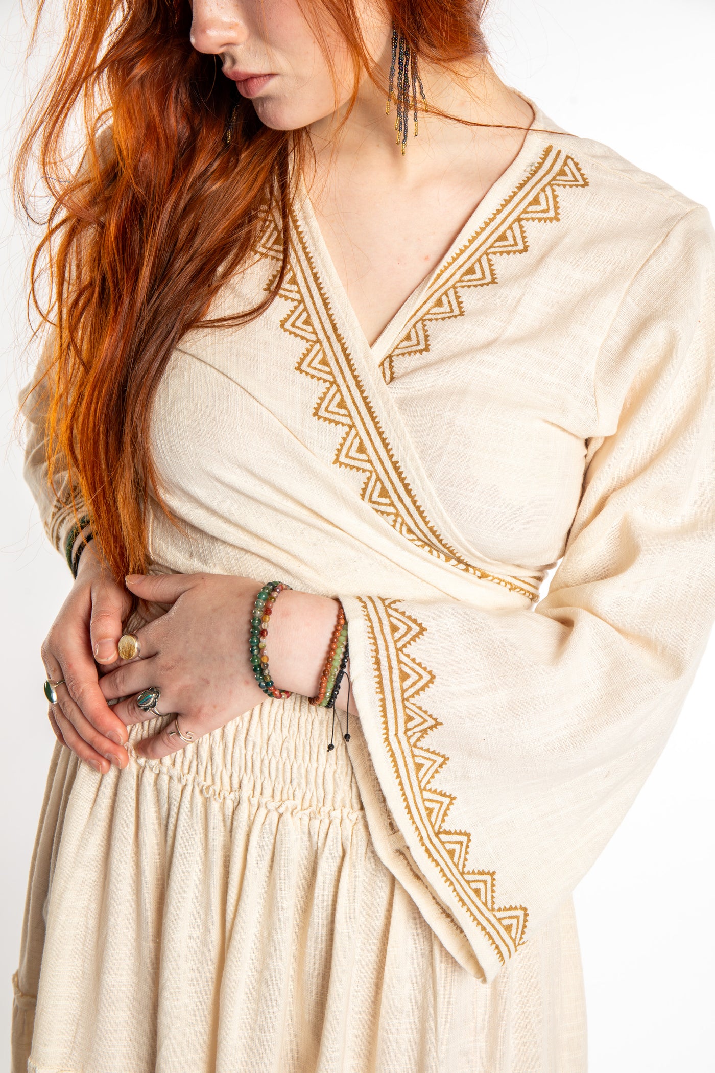 Honora is wearing Bohemian Wrap Top in Ivory