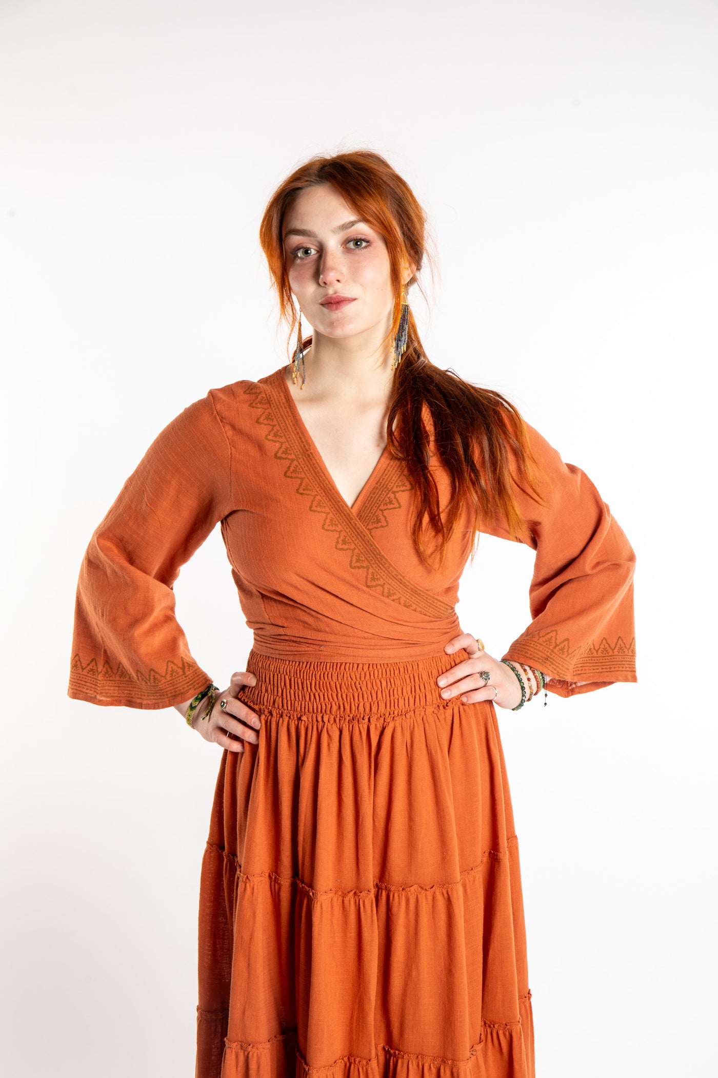 Honora is wearing Bohemian Wrap Top in Terracotta
