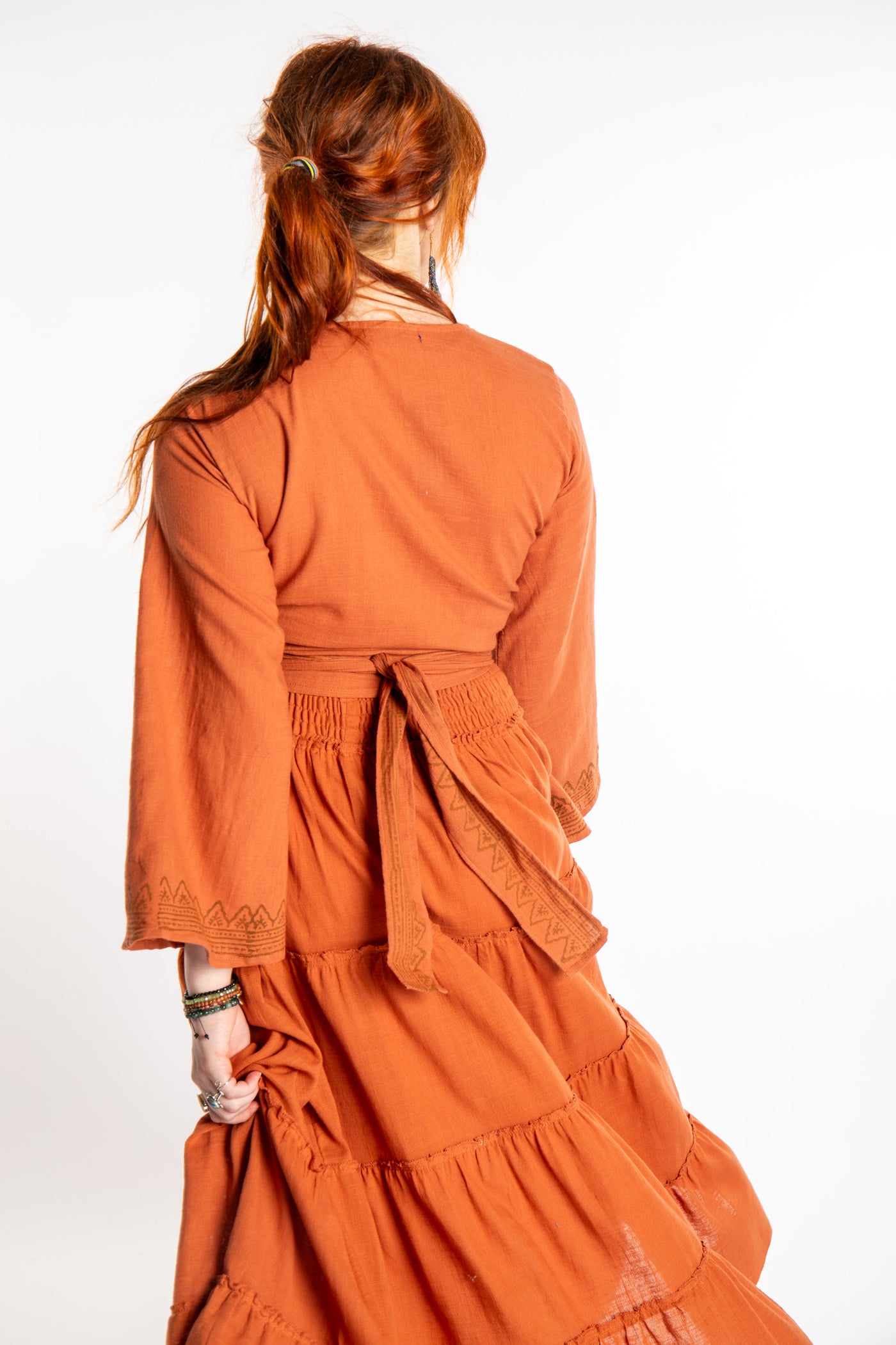 Honora is wearing Bohemian Wrap Top in Terracotta