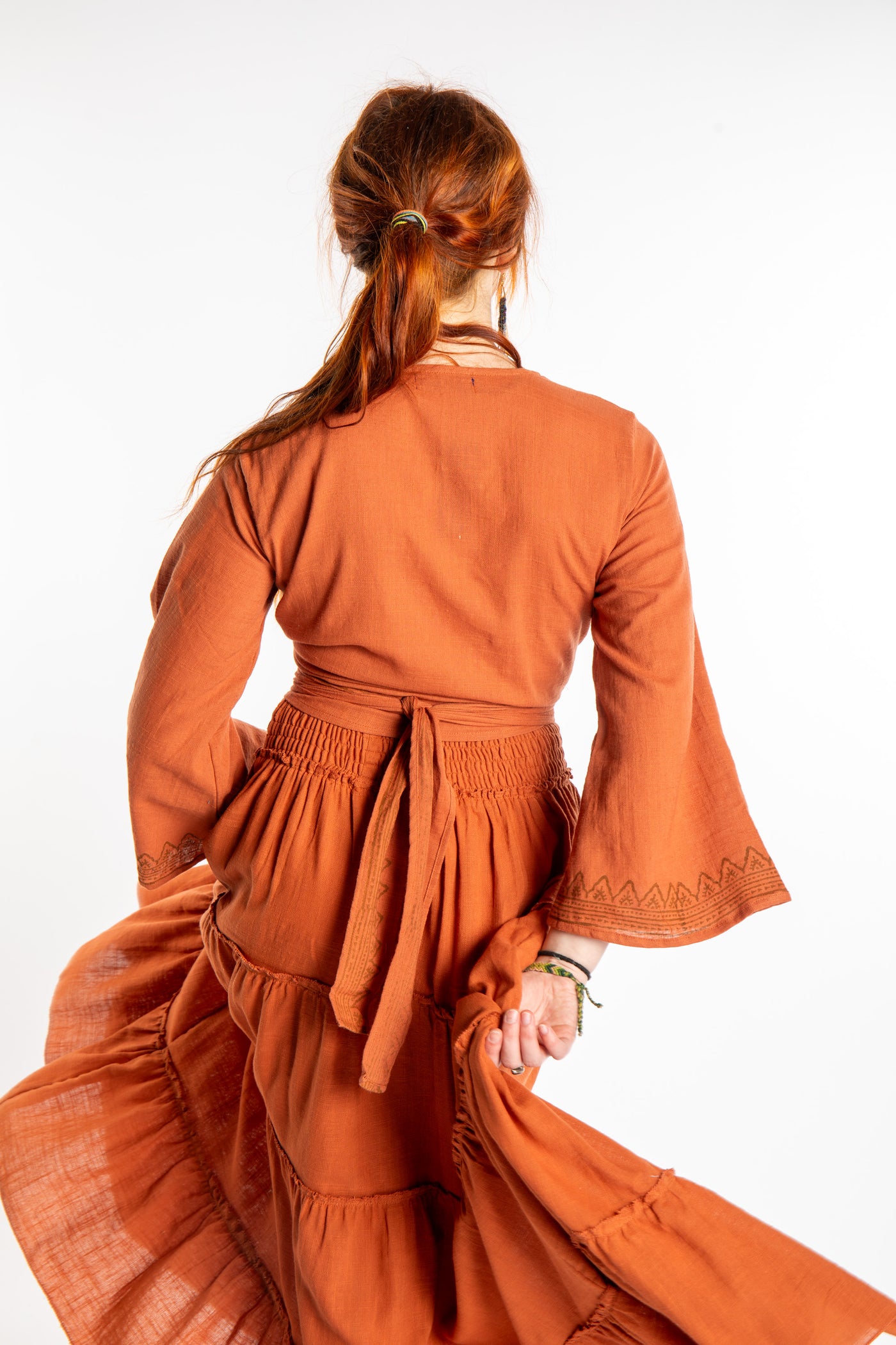 Honora is wearing Bohemian Wrap Top in Terracotta