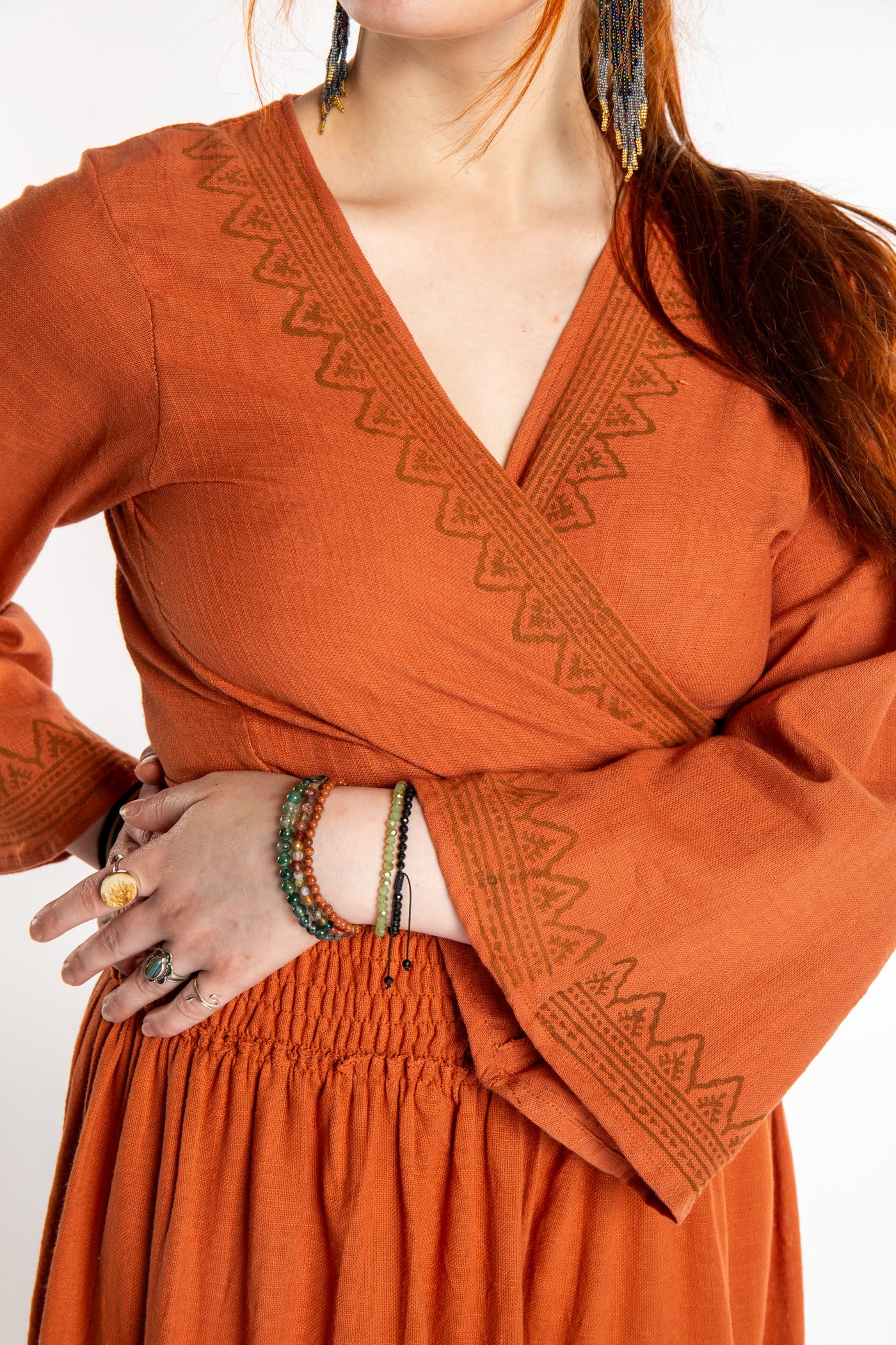 Honora is wearing Bohemian Wrap Top in Terracotta