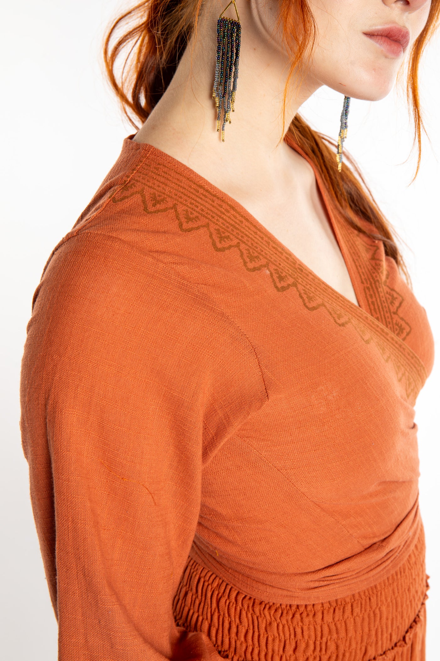 Honora is wearing Bohemian Wrap Top in Terracotta