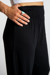 Sophie is wearing size S/M Solid Color Boho Pants in Black