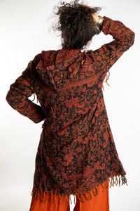 Susan wearing the orange and black multicolored paisley patterned blanket jacket 