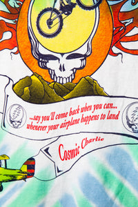 Colorful tie-dye shirt with a skull design, text, and airplane graphic.