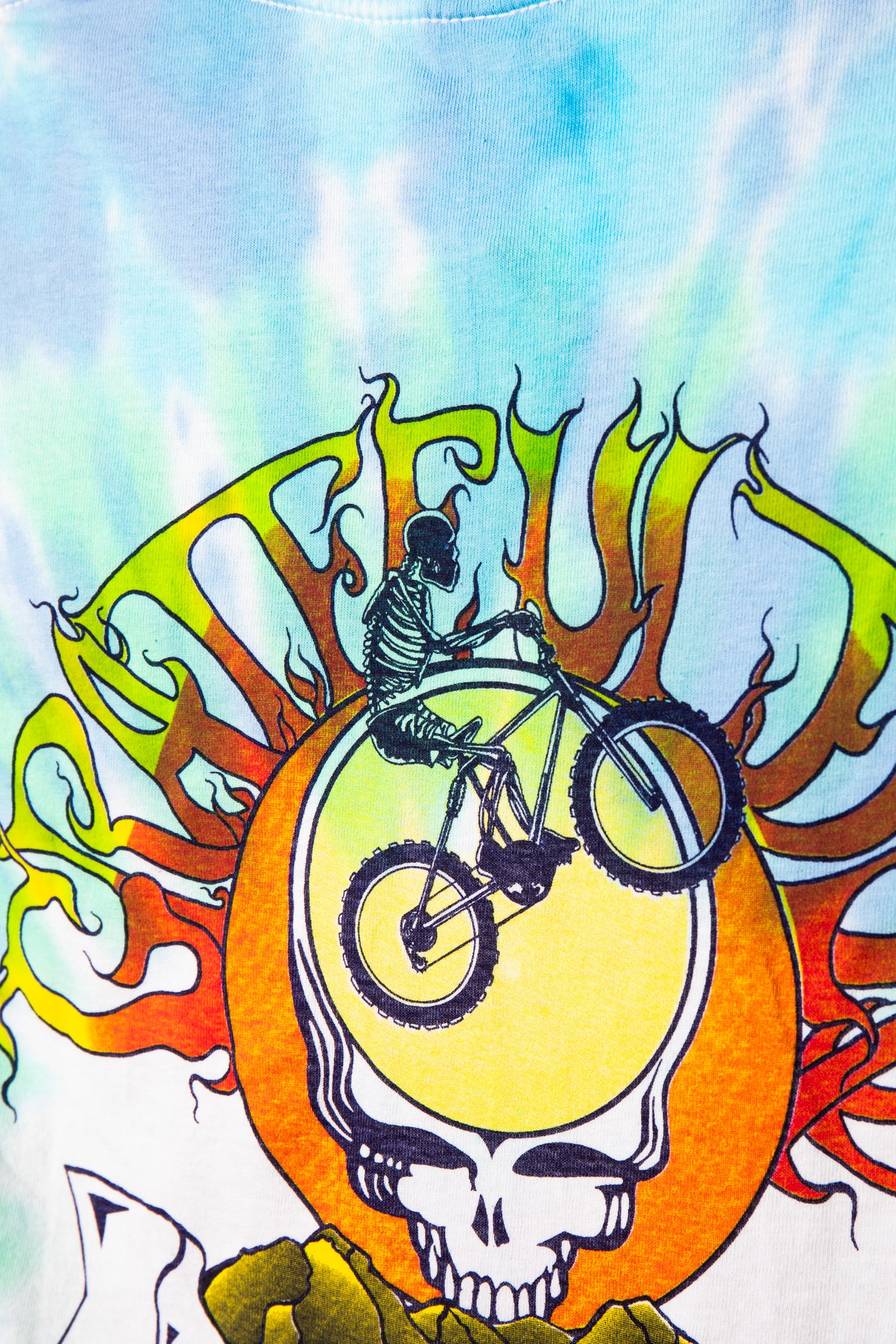 T-shirt with a skeleton on a bike and Grateful Dead logo design.