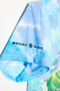 Tie-dye t-shirt with 'Mexicali Blues' logo on a light blue background