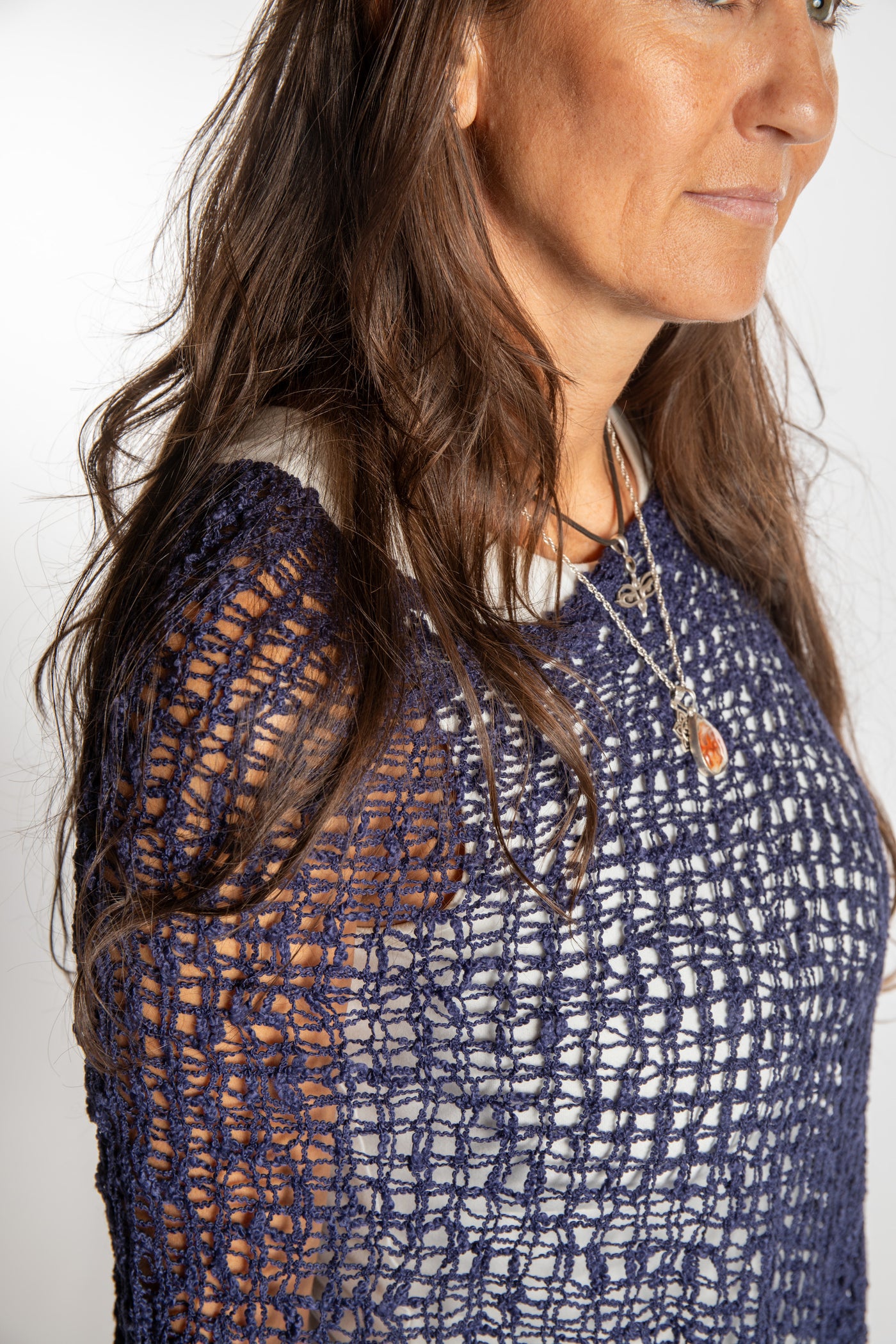 Jen is wearing the Navy loose weave shawl