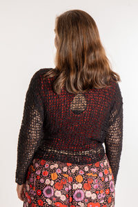 Holly is wearing the Black loose knit cardigan