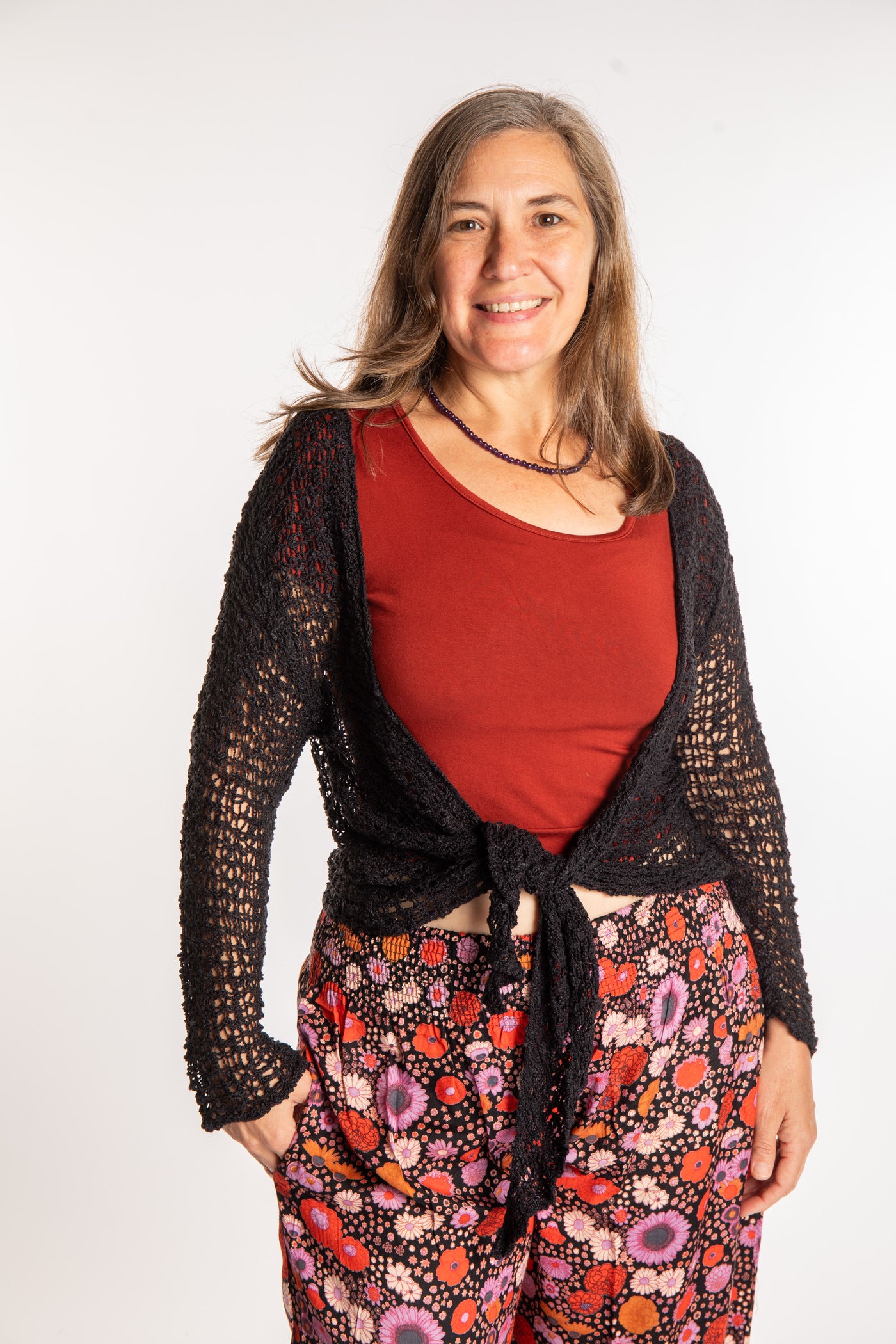 Holly is wearing the Black loose knit cardigan
