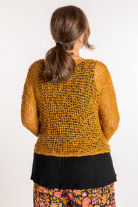 Holly is wearing the Ochre loose knit cardigan