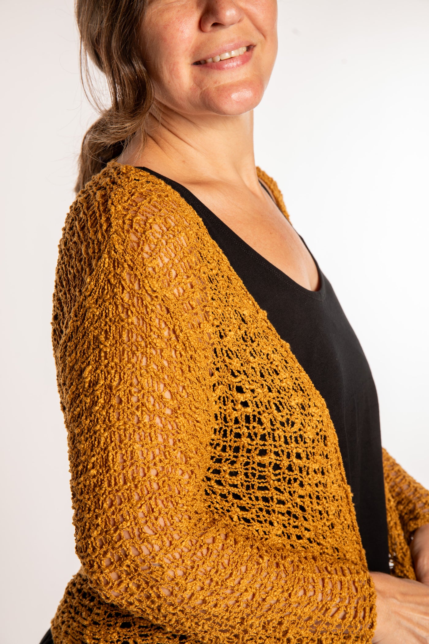 Holly is wearing the Ochre loose knit cardigan