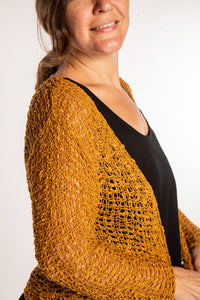 Holly is wearing the Ochre loose knit cardigan