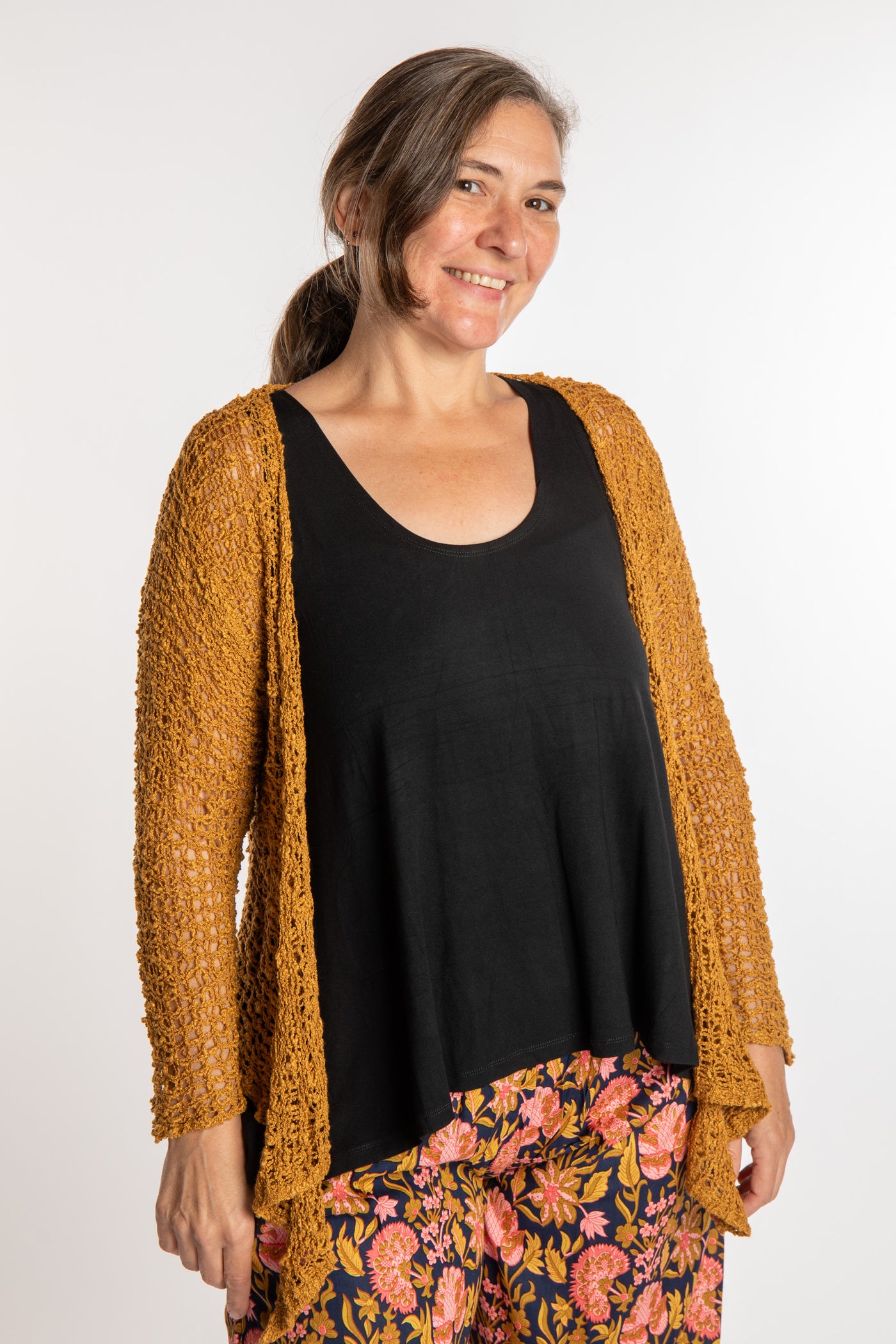 Holly is wearing the Ochre loose knit cardigan