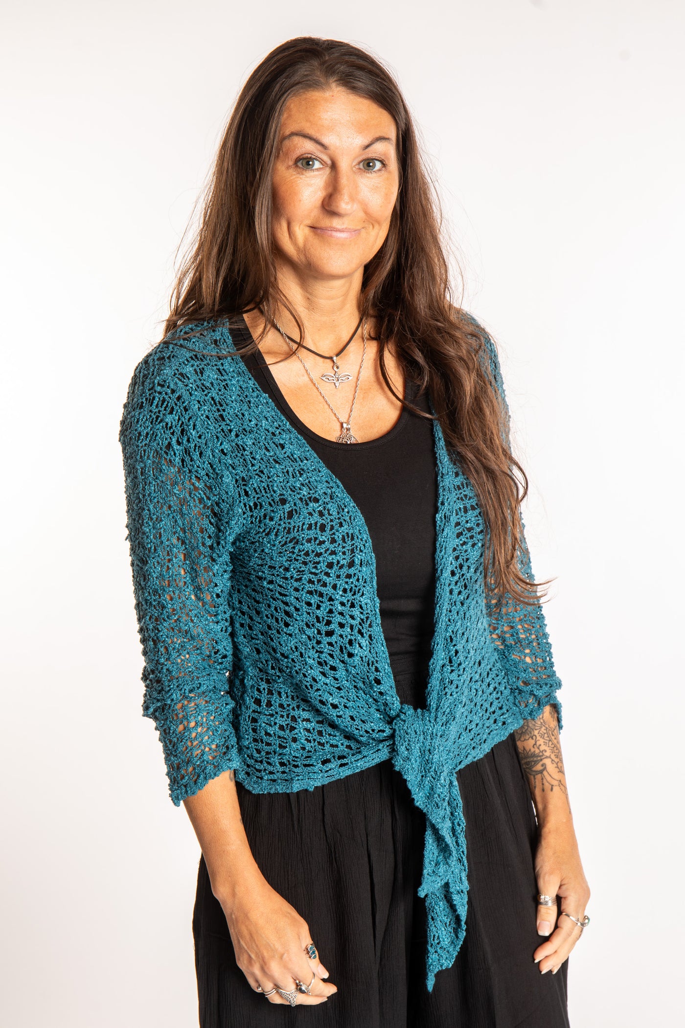 Jen is wearing the Teal loose knit cardigan
