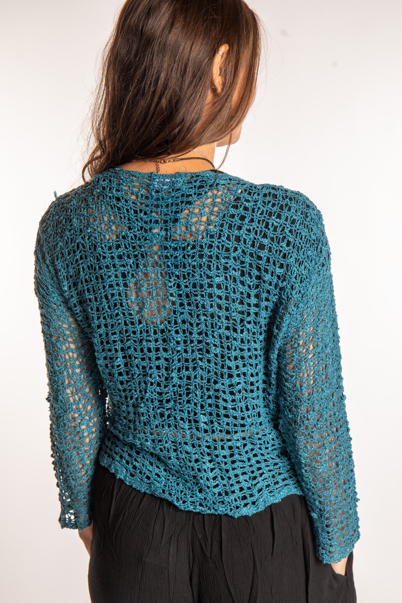 Jen is wearing the Teal loose knit cardigan