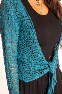 Jen is wearing the Teal loose knit cardigan