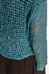 Jen is wearing the Teal loose knit cardigan