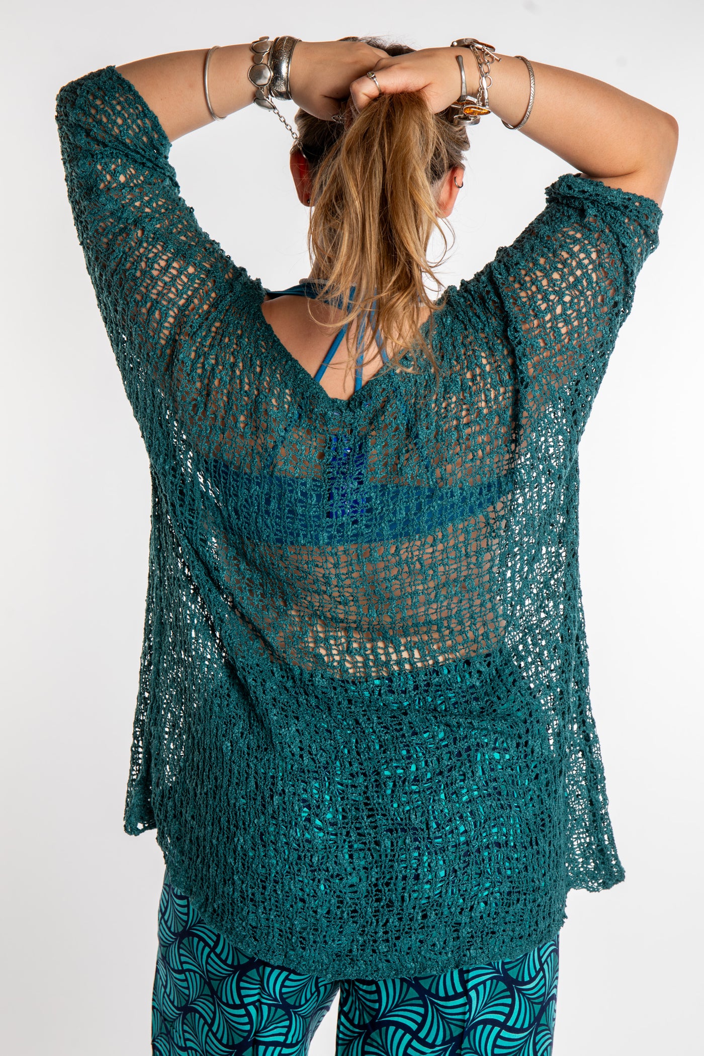 Emma is wearing the Aquamarine loose knit cover up