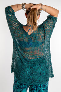 Emma is wearing the Aquamarine loose knit cover up