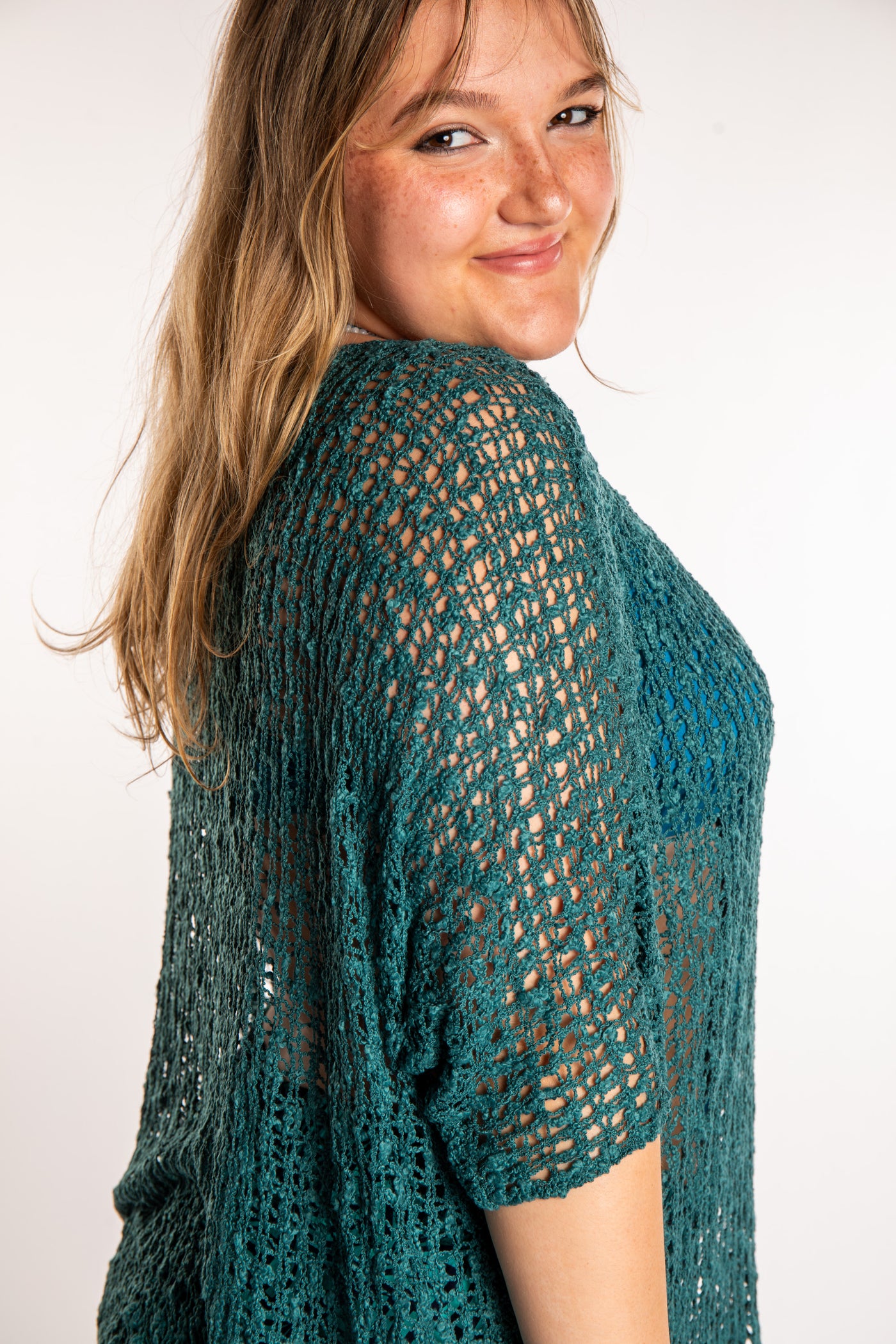 Emma is wearing the Aquamarine loose knit cover up