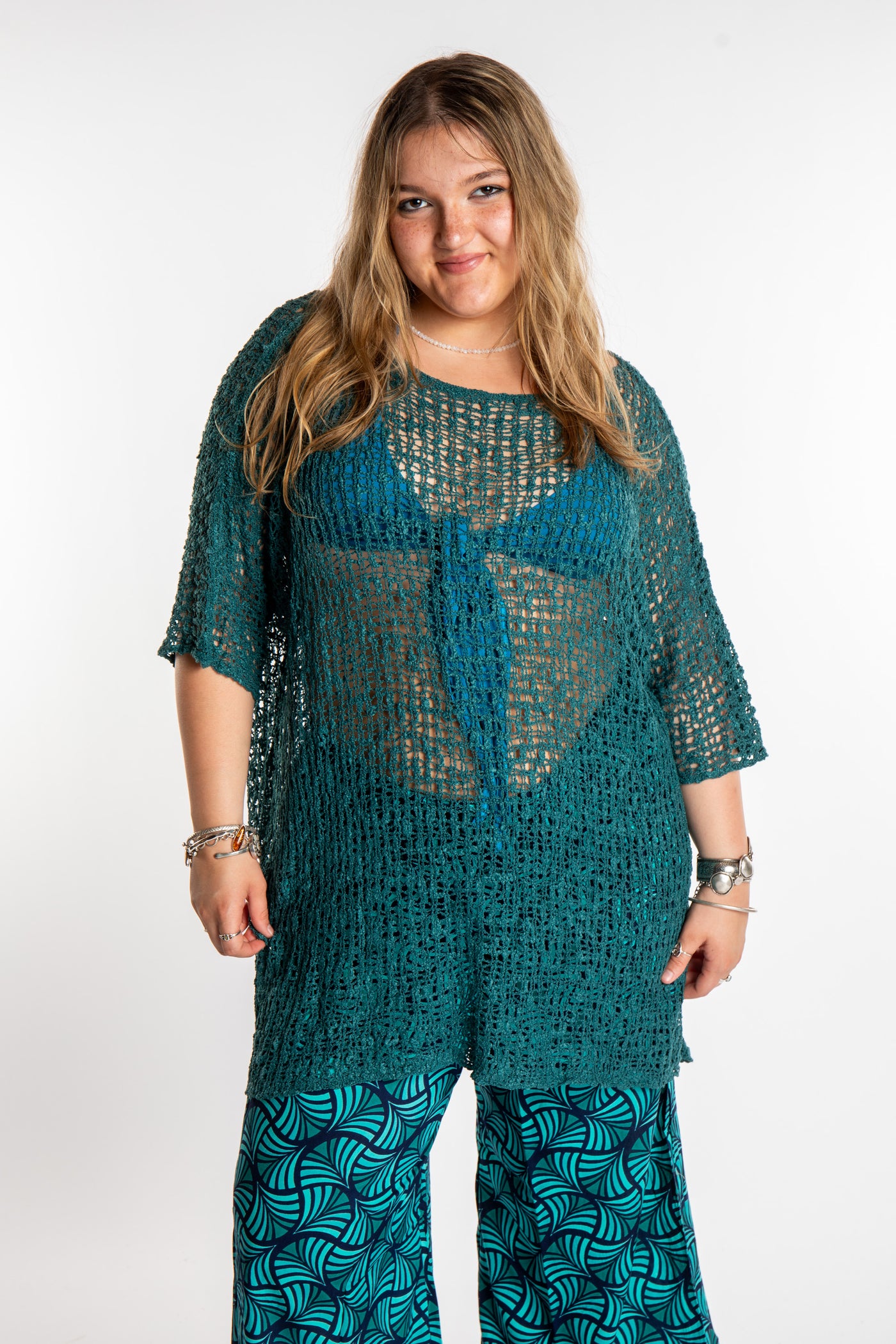 Emma is wearing the Aquamarine loose knit cover up