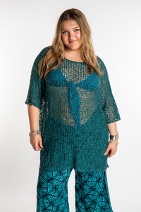 Emma is wearing the Aquamarine loose knit cover up
