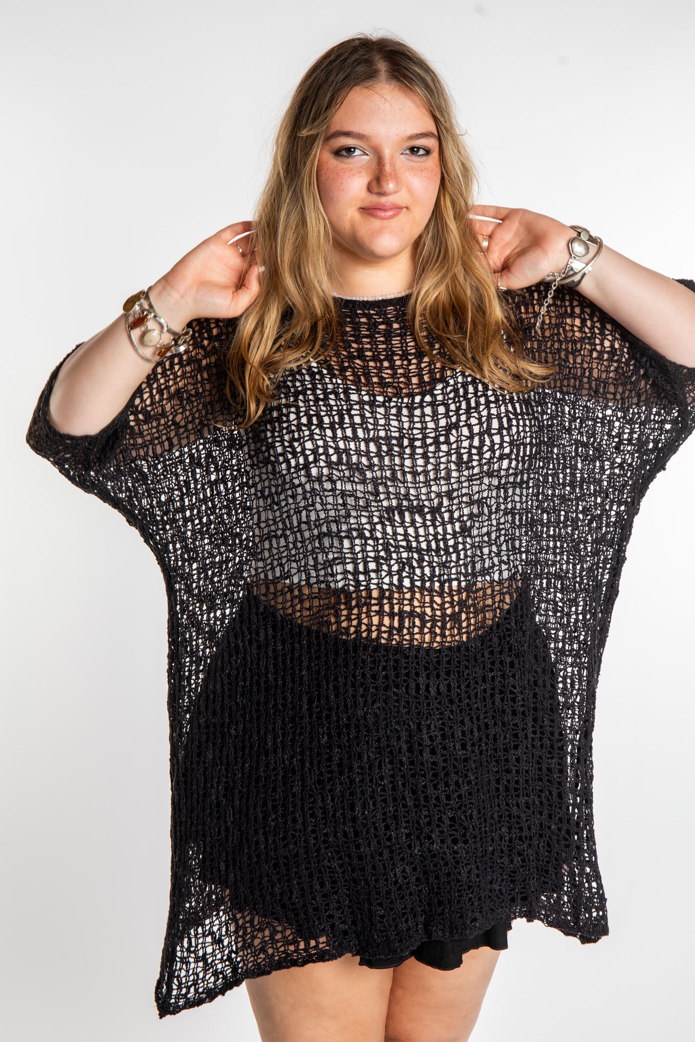 Emma is wearing the Black loose knit cover up