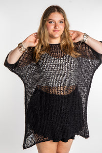 Emma is wearing the Black loose knit cover up