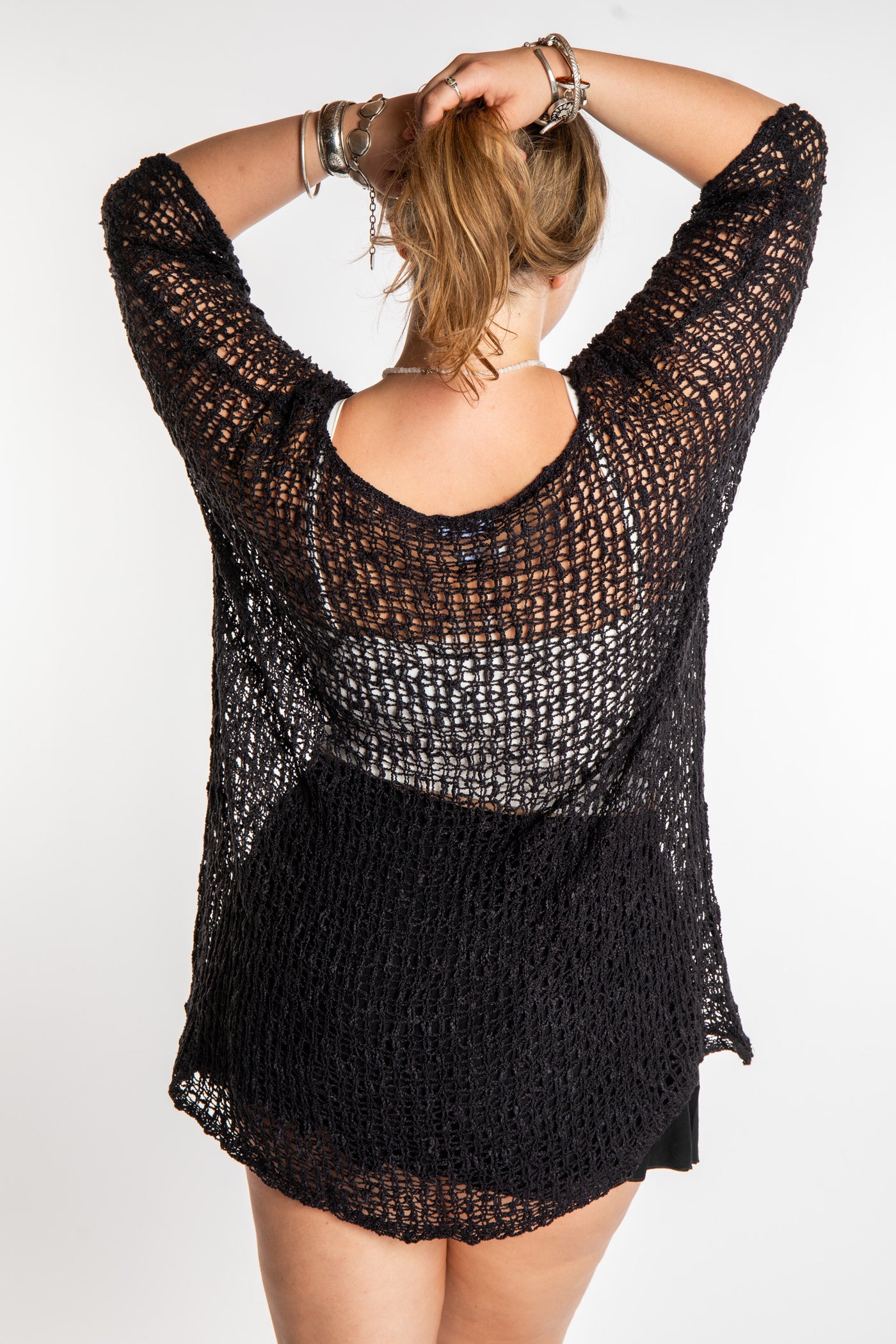Emma is wearing the Black loose knit cover up