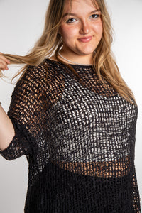 Emma is wearing the Black loose knit cover up