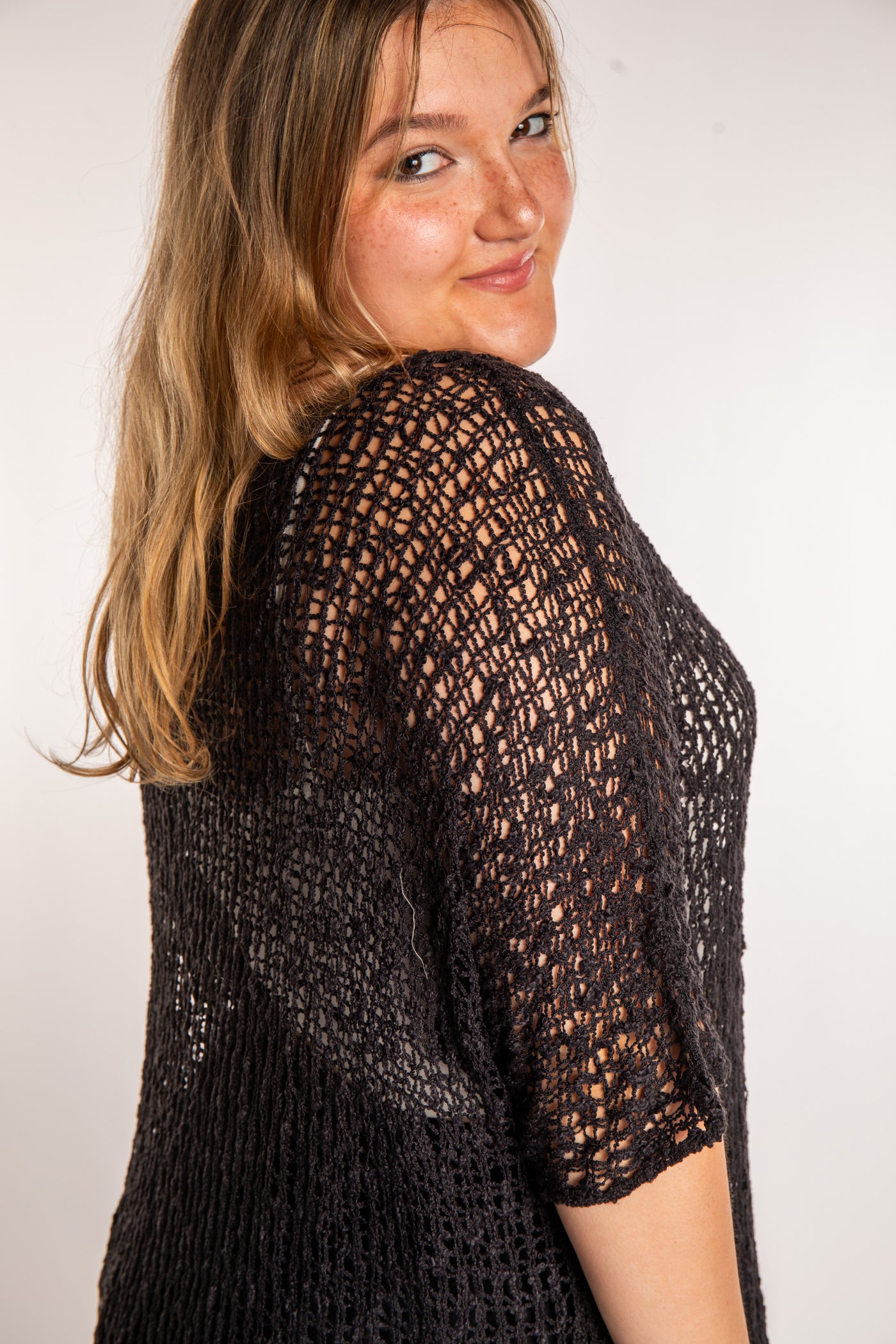 Emma is wearing the Black loose knit cover up