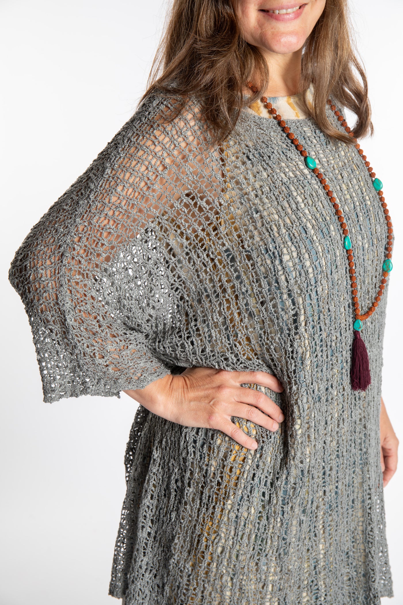 Holly is wearing the Gray loose knit cover up