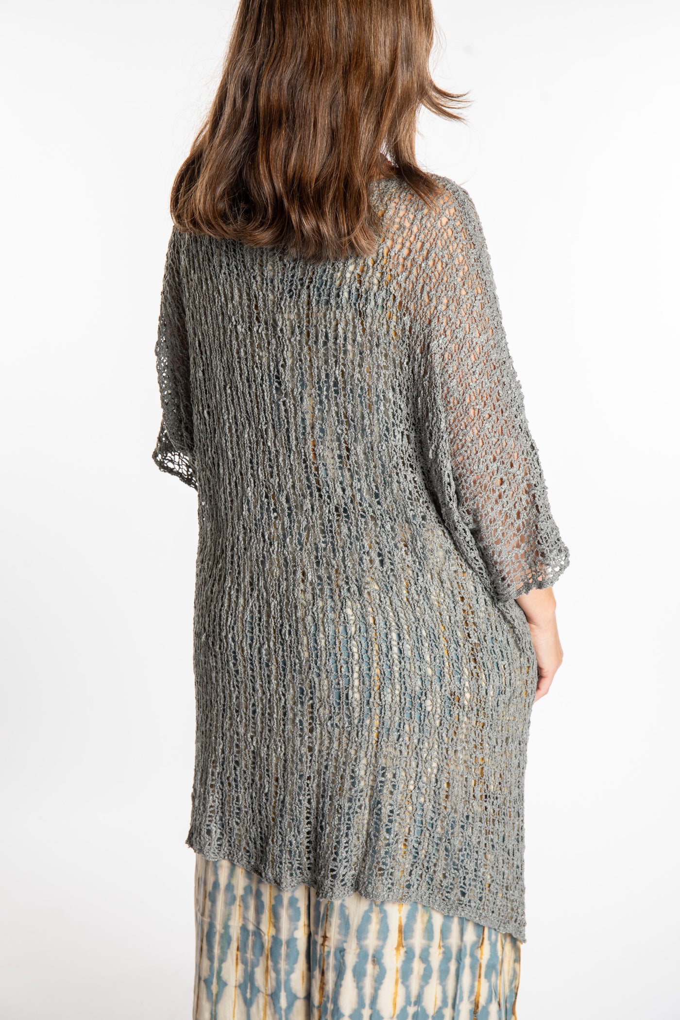 Holly is wearing the Gray loose knit cover up