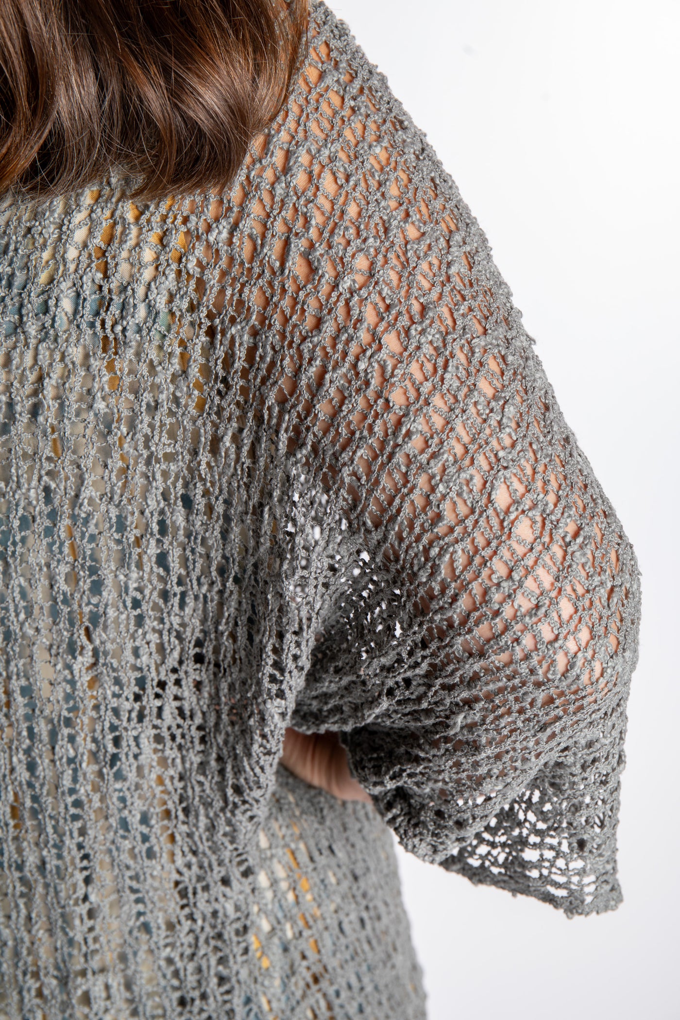 Holly is wearing the Gray loose knit cover up