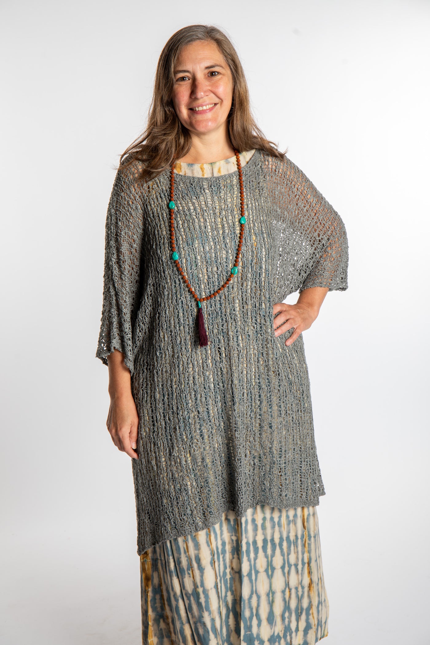 Holly is wearing the Gray loose knit cover up