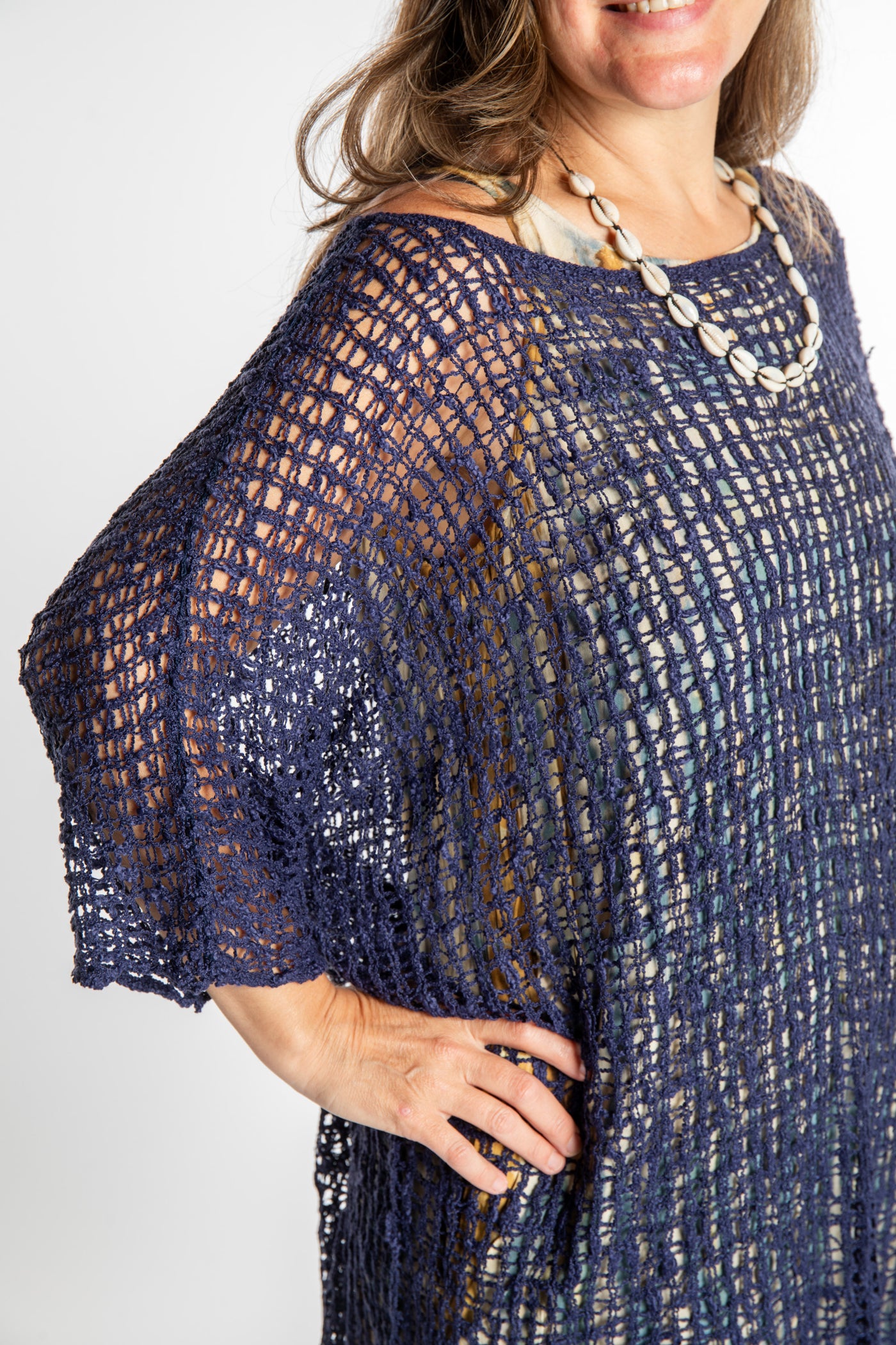 Holly is wearing the Navy loose knit cover up