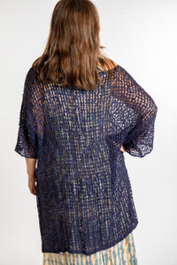 Holly is wearing the Navy loose knit cover up