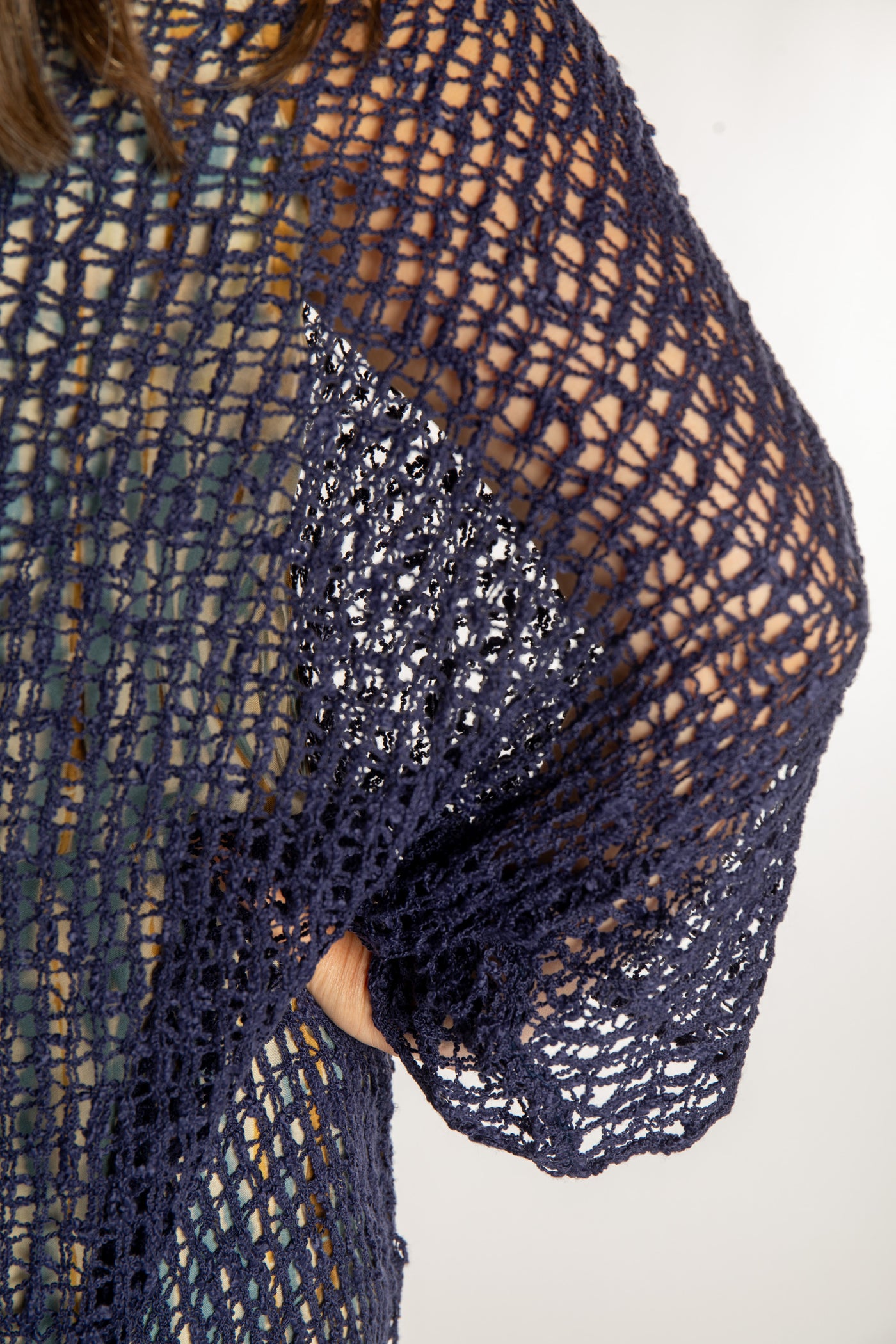 Holly is wearing the Navy loose knit cover up