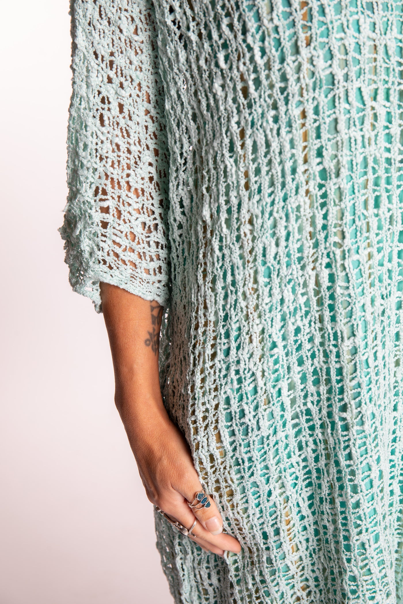 Jen is wearing the Seafoam loose knit cover up