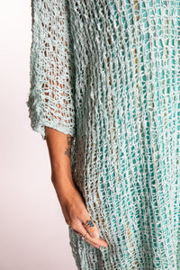 Jen is wearing the Seafoam loose knit cover up