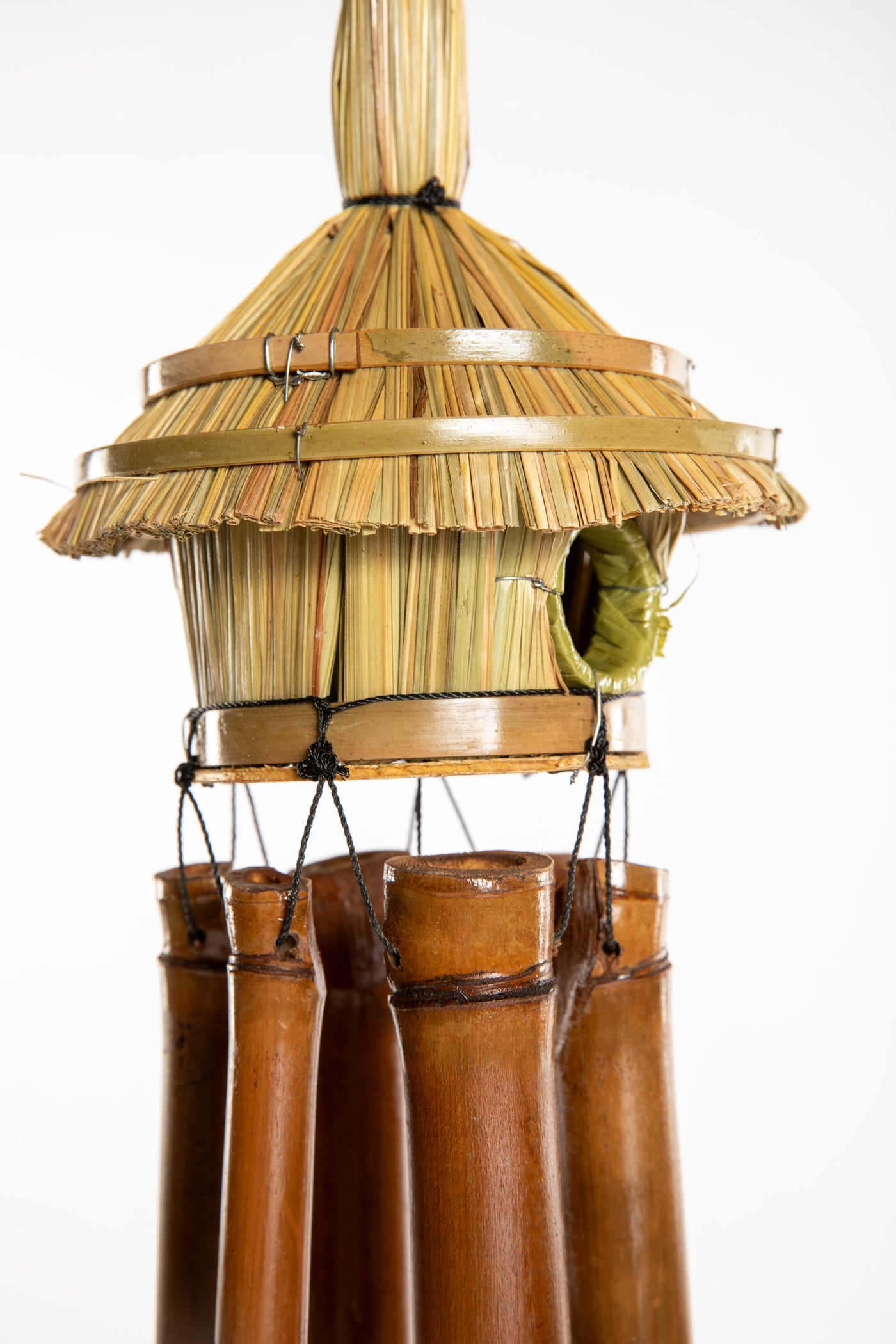 Bamboo wind chime with a thatched roof design