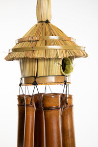 Bamboo wind chime with a thatched roof design