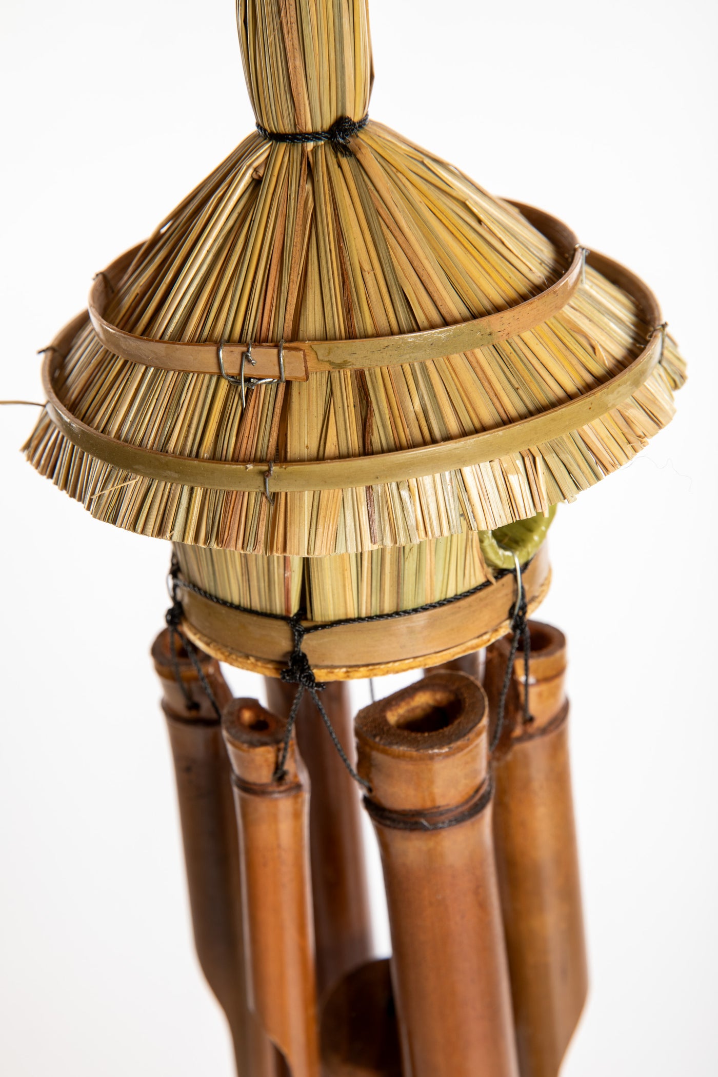 Bamboo wind chime with a thatched roof design