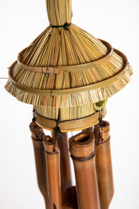 Bamboo wind chime with a thatched roof design