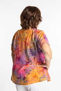 Betty is wearing a size Large batik tunic in Watermelon