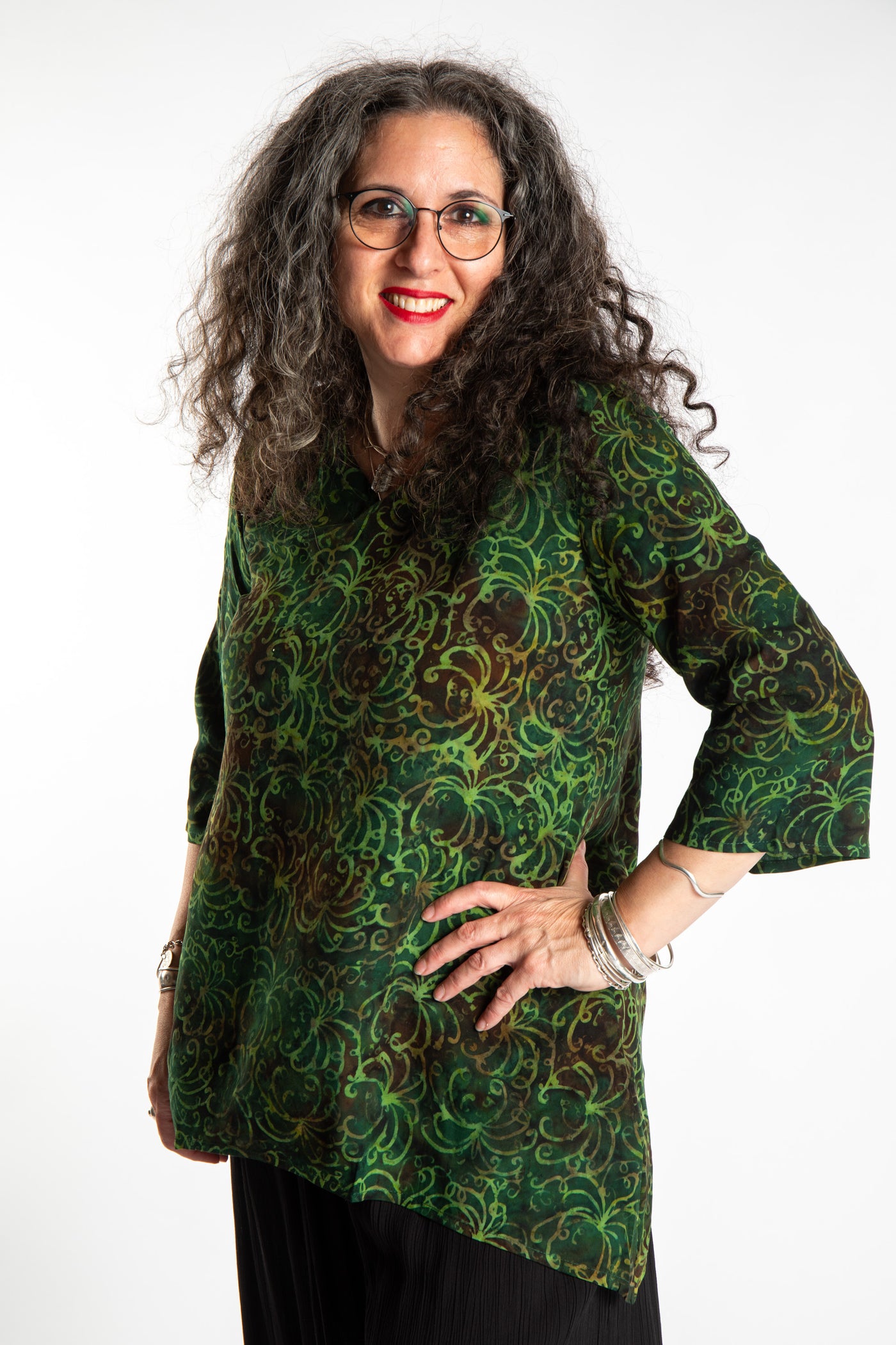 Susan wearing the M/L Emerald Green floral batik tunic top