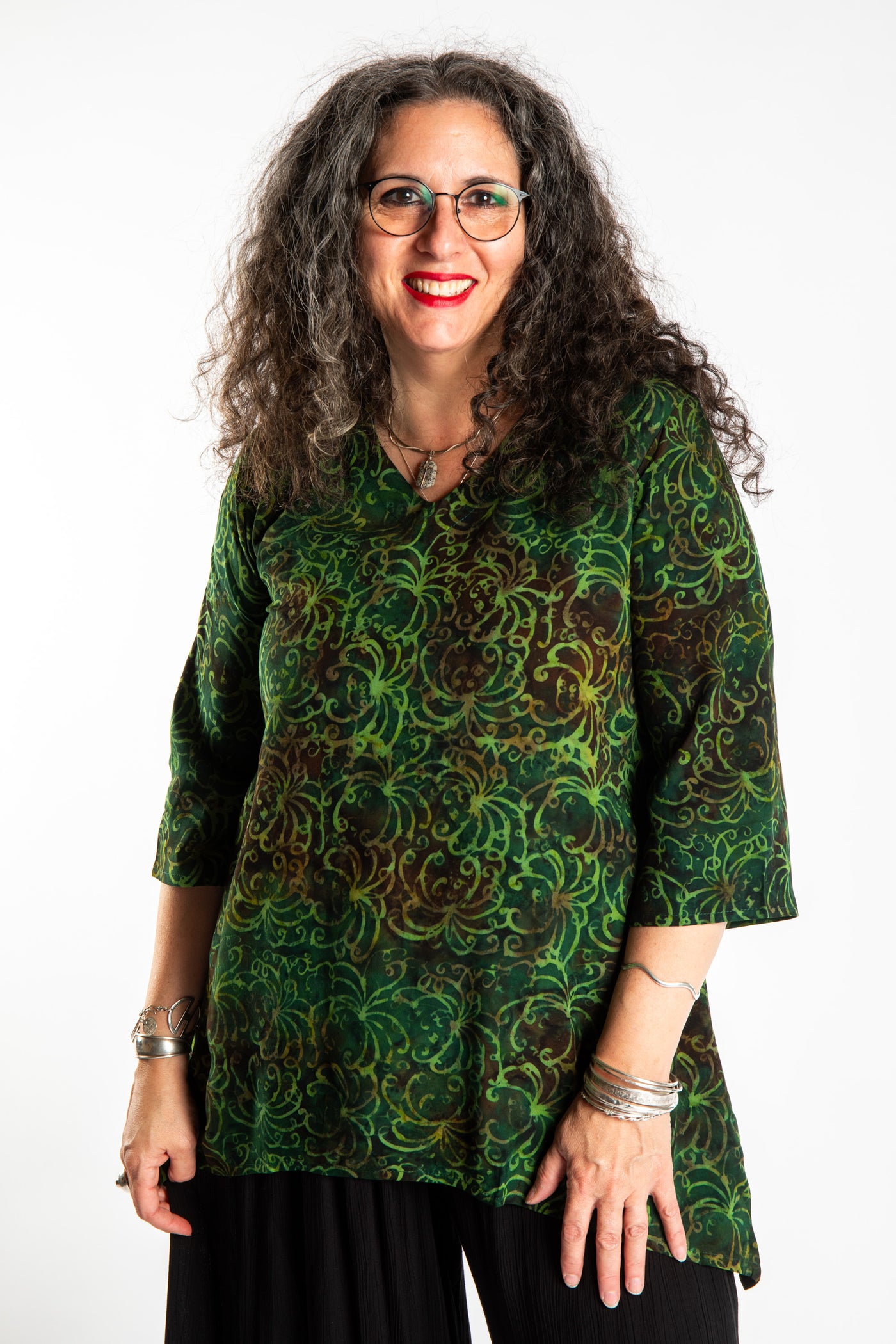 Susan wearing the M/L Emerald Green floral batik tunic top