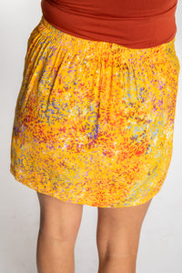 Sophie is wearing the Sunshine Yellow Juna Batik Pencil Skirt in size S/M