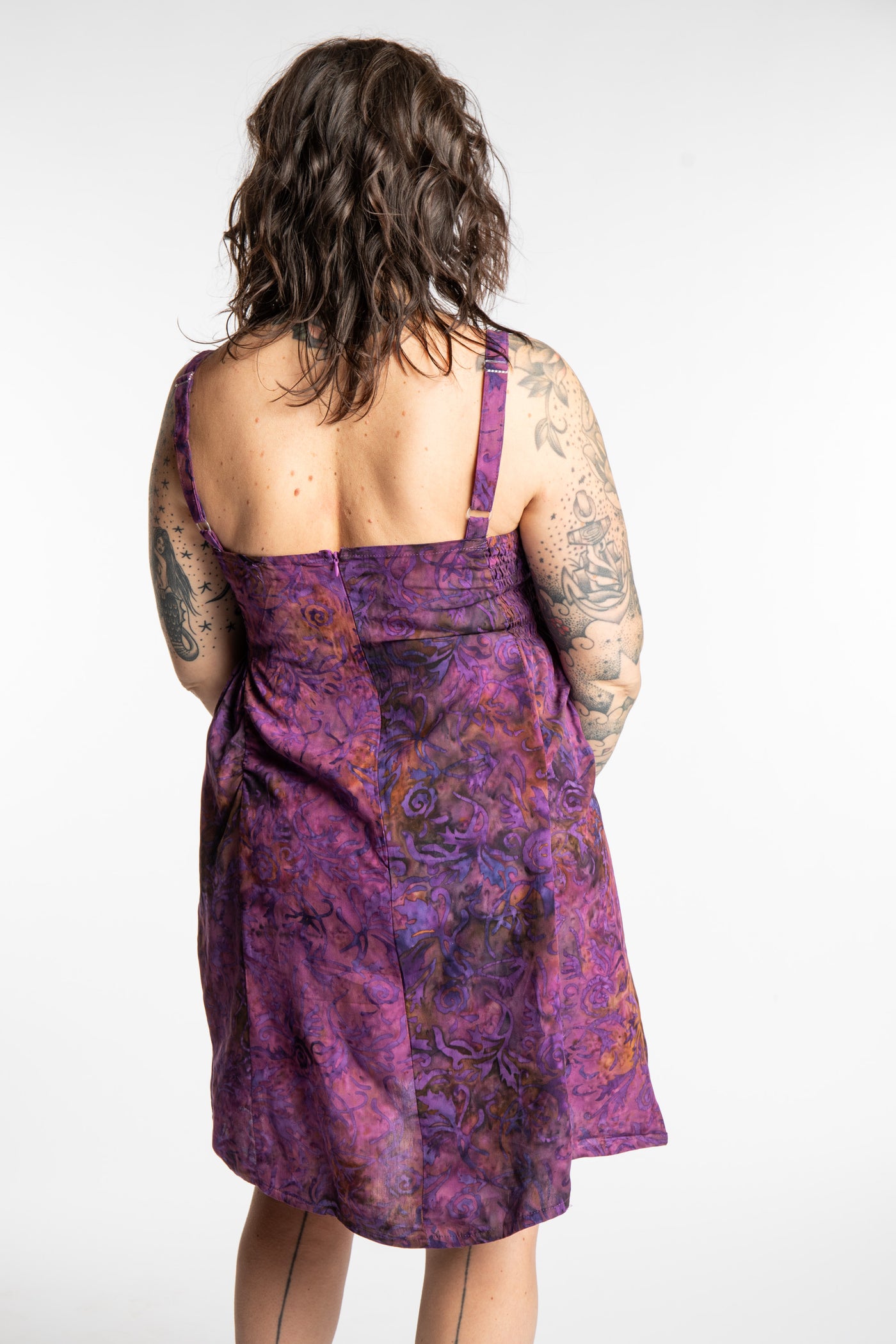 Morgan is wearing the Purple Paradise Surya Batik Sundress in size M 